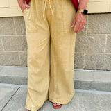 Golden wide-leg linen-blend pants with drawstring waist and square pockets—lightweight and perfect for casual gameday style
