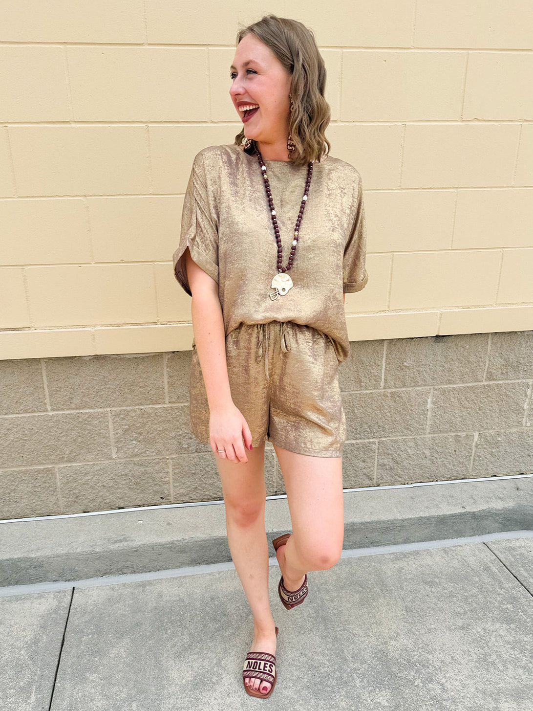 Metallic gold loungewear set with short dolman sleeve U-neck top and matching drawstring shorts