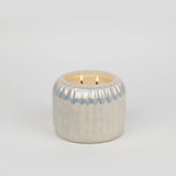 Iridescent pearl-toned candle with a ribbed surface and dual wicks, styled as elegant home décor