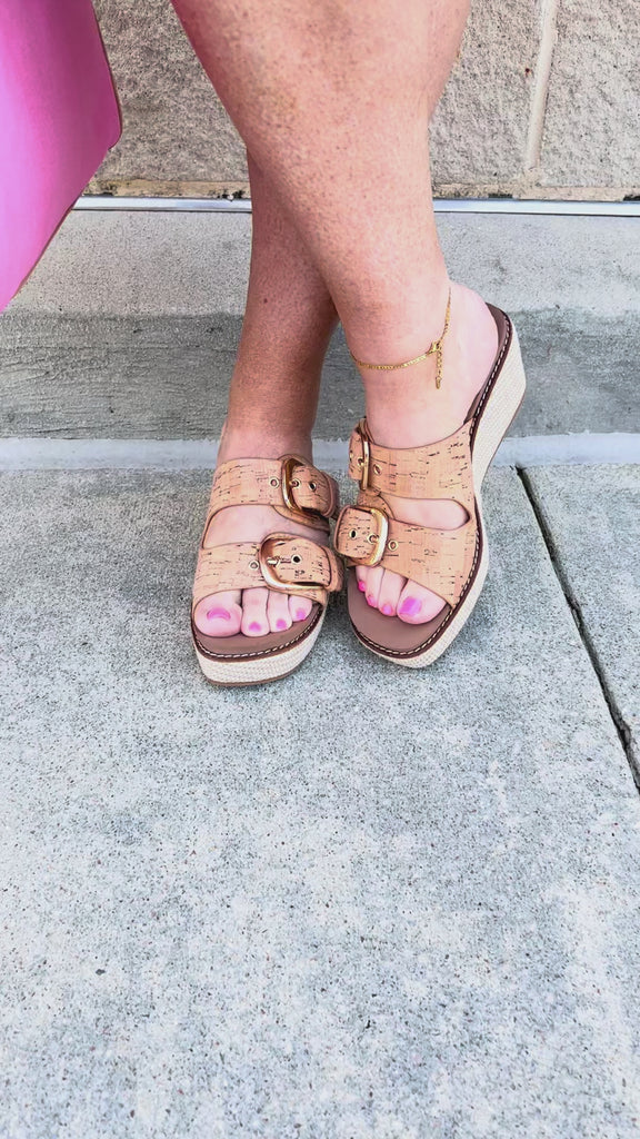 Cork wedge sandals with adjustable straps and buckle detail.