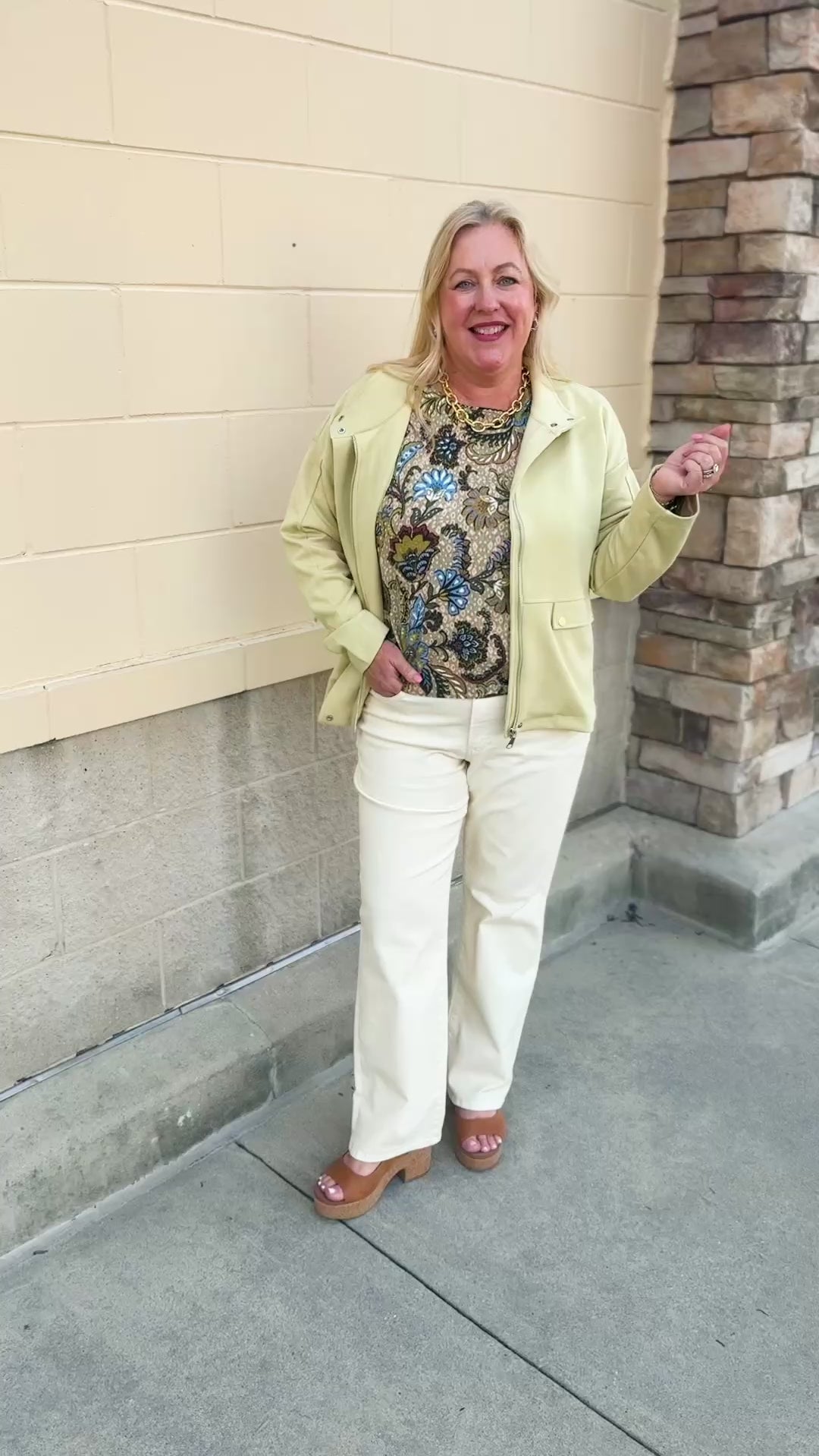 Light yellow zip-up jacket with a fold-over collar and two front button pockets.