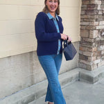 Navy blue long-sleeve sweater jacket with a denim collar, denim center-front trim, and gold buttons.