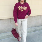Garnet crewneck sweatshirt with dropped shoulders and gold chenille “Noles” script lettering.