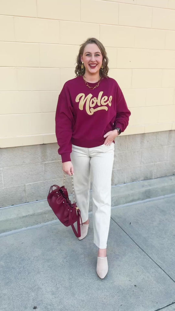 Garnet crewneck sweatshirt with dropped shoulders and gold chenille “Noles” script lettering.
