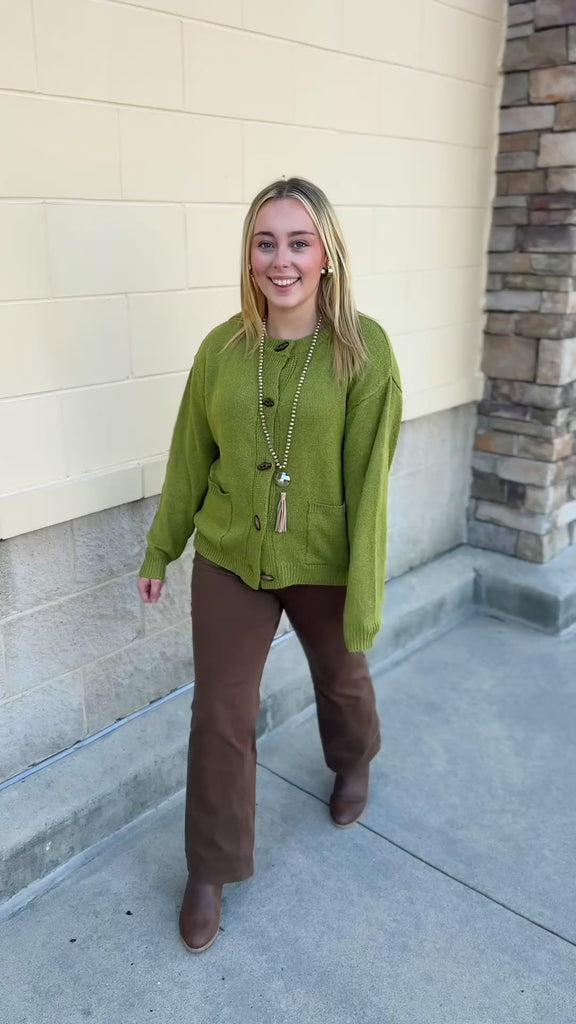 Olive Charm Cardigan in olive green with long sleeves, oval buttons, and front pockets