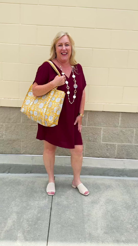 Garnet short sleeve mini dress with deep V-neck, drop shoulders, and side pockets—perfect for gameday.