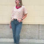 Bright floral v-neck top with dolman sleeves and drop shoulder design, styled for a relaxed and feminine look.