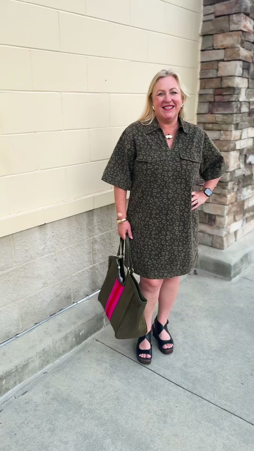 Dark olive green denim dress with a lighter green leopard print, collared V-neckline, and two front patch pockets