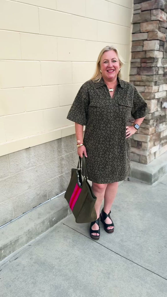 Dark olive green denim dress with a lighter green leopard print, collared V-neckline, and two front patch pockets