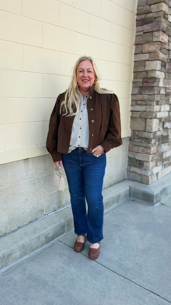 Hazelnut brown jacket with five front buttons, shoulder button accents, and a versatile high neckline