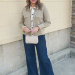 Khaki long-sleeve sweater-material jacket with a button-up front, folded fur collar, and two front pockets.
