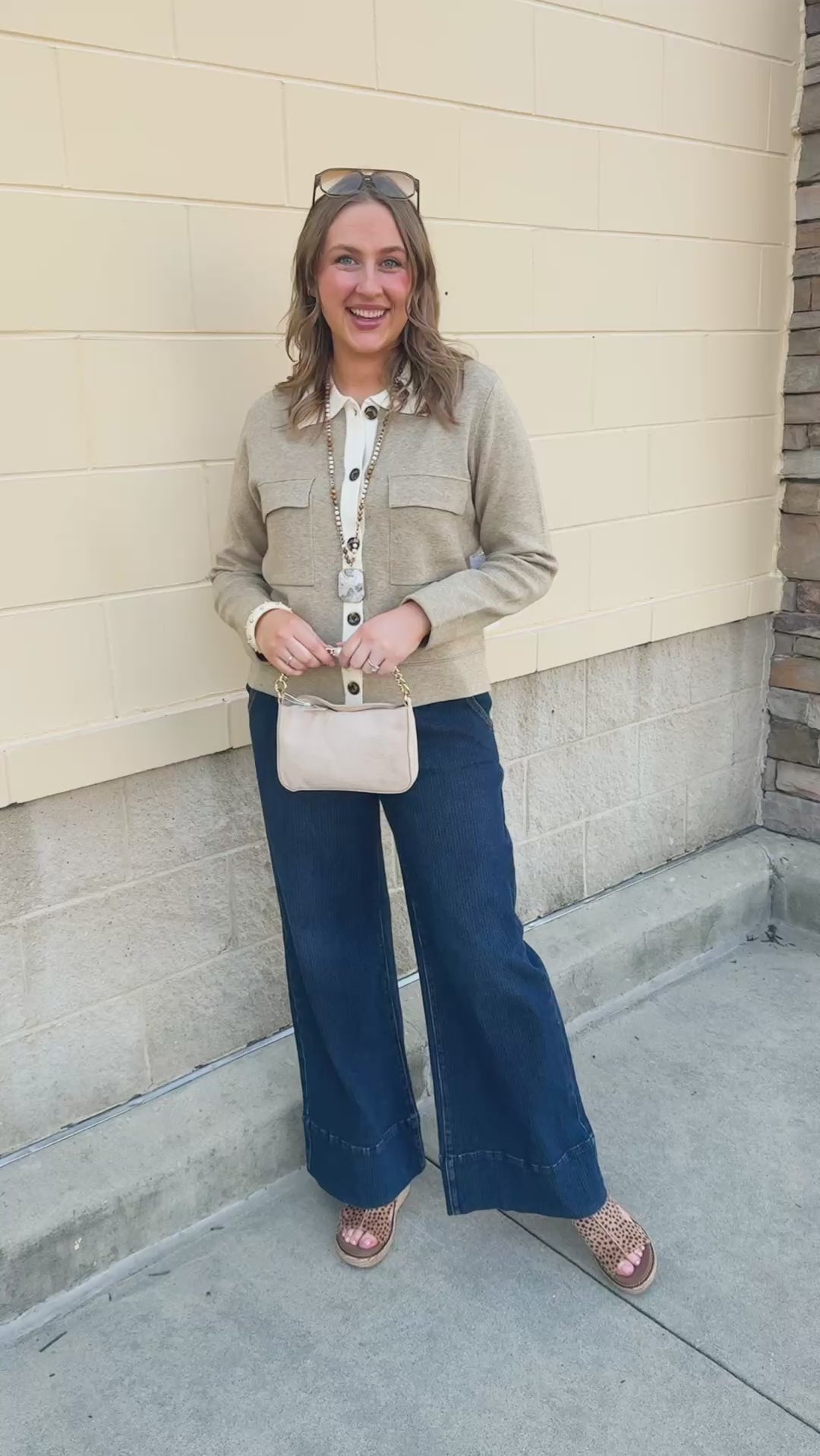 Khaki long-sleeve sweater-material jacket with a button-up front, folded fur collar, and two front pockets.