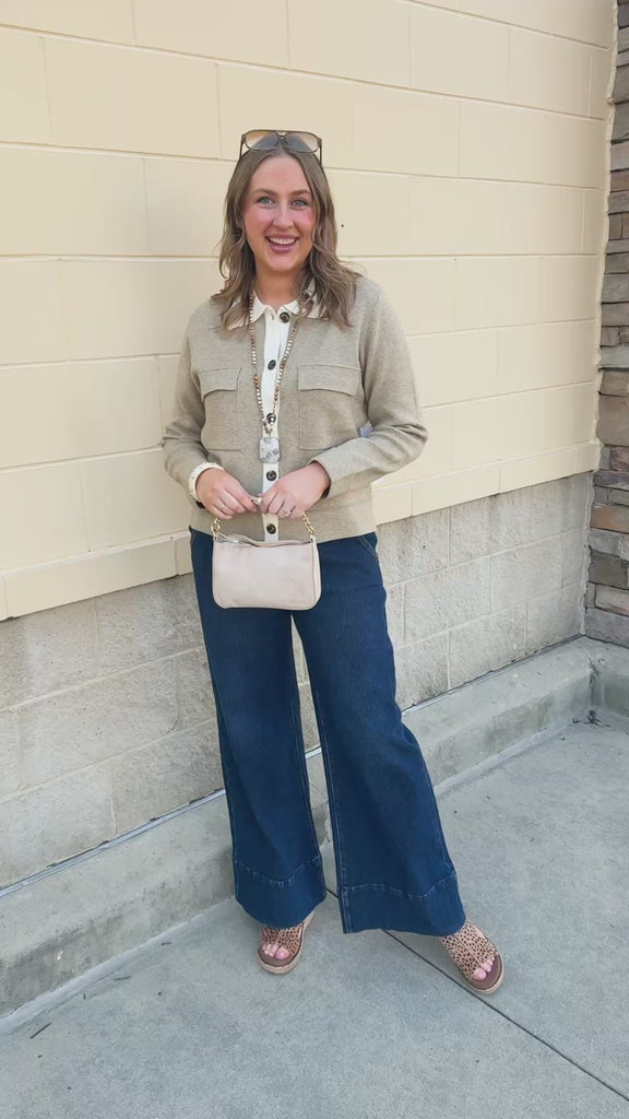 Khaki long-sleeve sweater-material jacket with a button-up front, folded fur collar, and two front pockets.