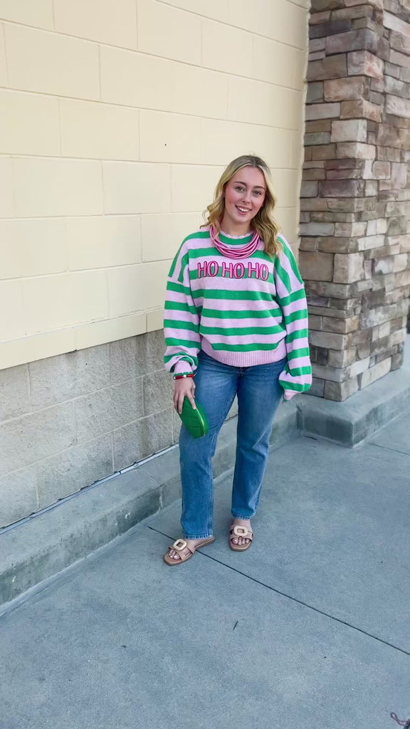 Ho Ho Ho Striped Sweater with pink and green stripes, festive lettering, and scalloped trim