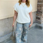 Ivory short-sleeve knit top with subtle tonal criss-cross texture