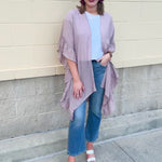 Mauve ruffle duster cardigan with open front and ruffled detailing along sides and sleeves.