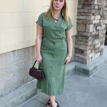 Eucalyptus green maxi dress with a collared V-neckline, full button-down front, chest pockets, and built-in tie belt.