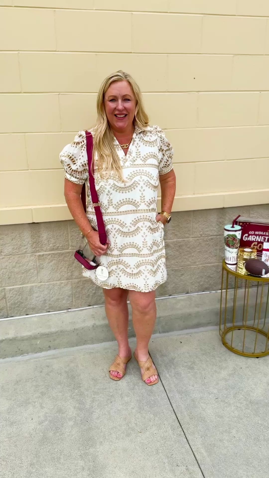 Cream mini dress with taupe geometric eyelet pattern, puffed sleeves, open collar, and side pockets