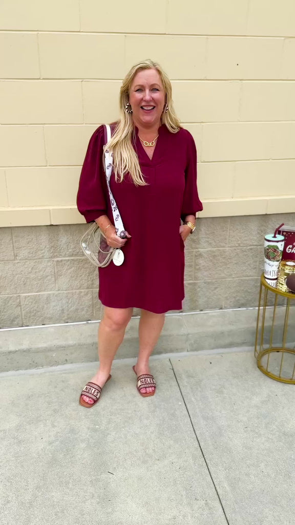 Garnet mini dress with a split U-neckline, flowy fit, and three-quarter peasant sleeves with banded cuffs. Lightweight and perfect for Gameday style.