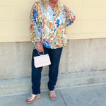 Floral chiffon blouse with frilled neckline, button front, dolman sleeves, and lightweight, flowy fit.