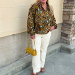 Cider-colored long-sleeve blouse with detailed leafy pattern, ruffled collar, V-neckline, and gathered sleeve cuffs