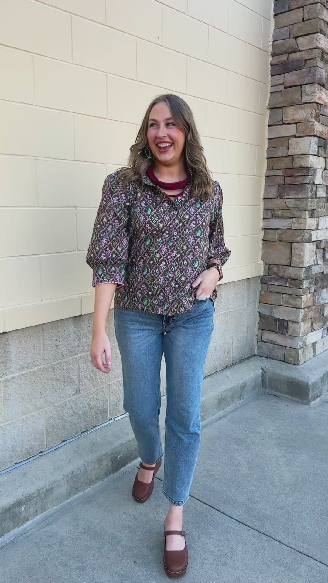 Blooming Trellis Blouse featuring a dark green background, pink diamond pattern with floral details, pink buttons, and long sleeves.