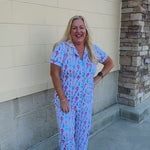 Whimsical Wonders Pajama Set featuring a short-sleeve collared top and matching long pants with colorful Christmas ornaments on a white background