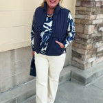 Navy nylon zip-up vest featuring two front pockets and an additional zippered front pocket.