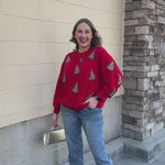 [Mary Square] Tinsel & Trees Sweater featuring a red background and festive Christmas tree details