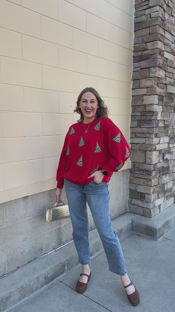 [Mary Square] Tinsel & Trees Sweater featuring a red background and festive Christmas tree details