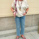 Cream and gold striped round-neck top with dolman sleeves and elastic cuffs, styled for summer.