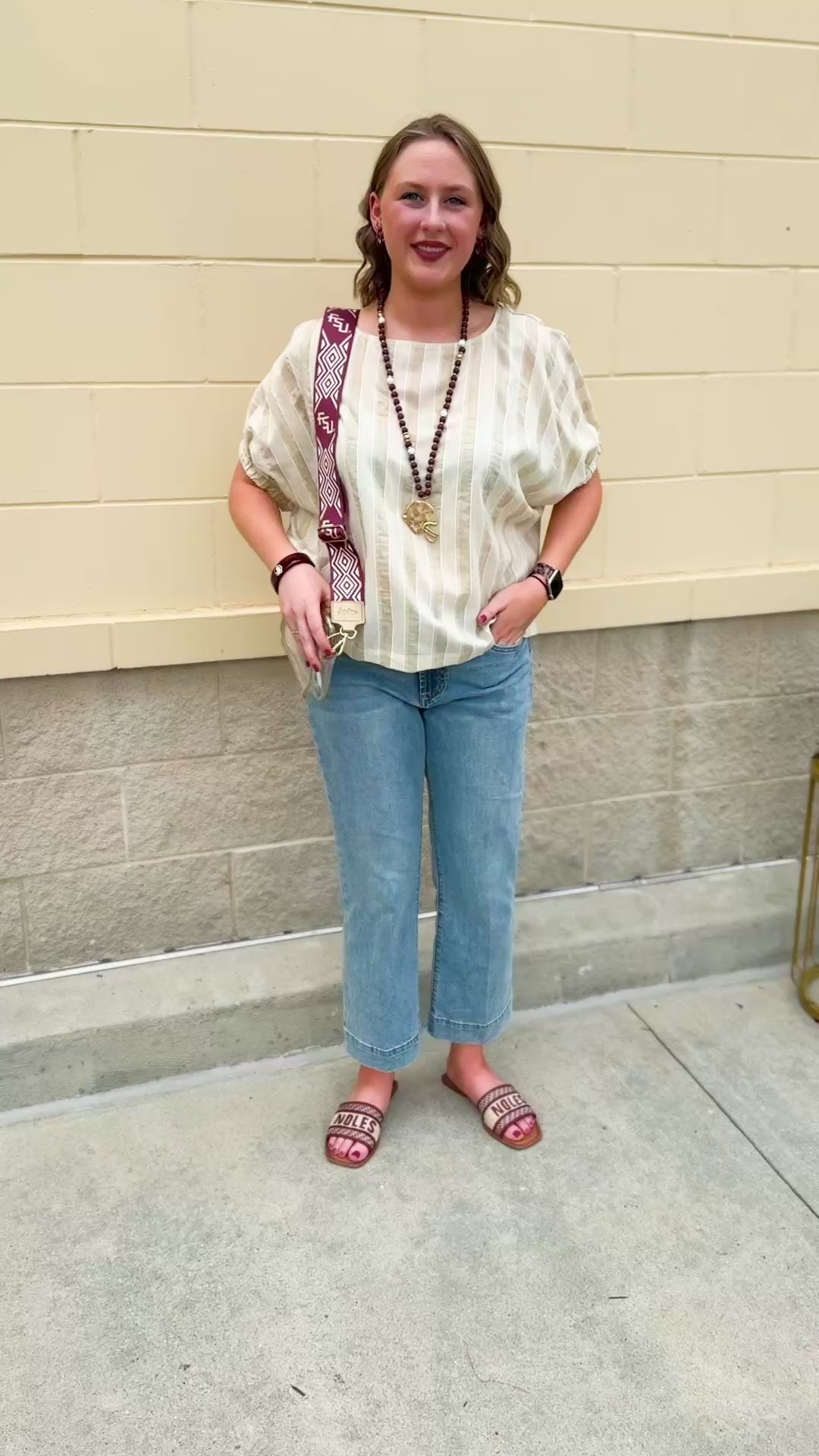 Cream and gold striped round-neck top with dolman sleeves and elastic cuffs, styled for summer.