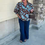 Entro Earthbound Floral Top with a brown background, blue layered floral print, button-down front, and three-quarter sleeves