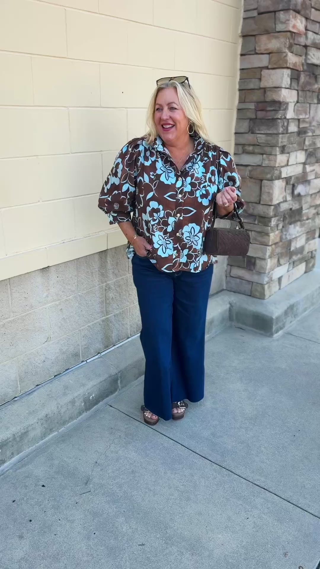 Entro Earthbound Floral Top with a brown background, blue layered floral print, button-down front, and three-quarter sleeves
