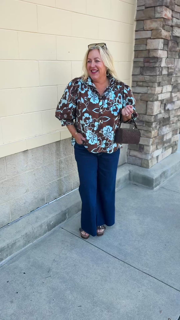 Entro Earthbound Floral Top with a brown background, blue layered floral print, button-down front, and three-quarter sleeves