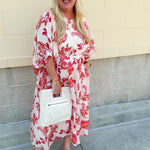 Cream midi dress with pink and orange floral print, scoop neckline, elastic waist, and flowy dolman sleeves.