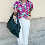 Vibrant raspberry floral blouse with ruffle-trimmed split neckline and short puff sleeves