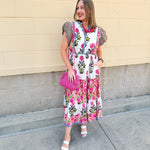 White cotton floral tiered maxi dress with flutter sleeves and ruffle collar