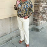 Long-sleeve top with an old-world floral print in shades of green, blue, purple, and yellow