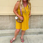 Sleeveless mustard cotton gauze dress with V-neckline, raw frayed edges, and front pockets. Lightweight and casual—ideal for Gameday or fall outings.