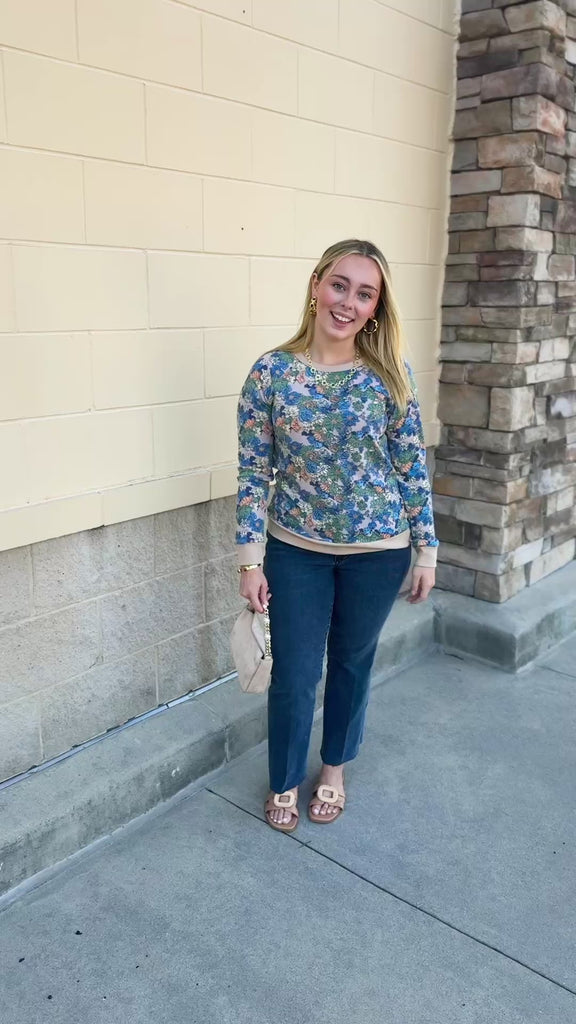 Harvest Bloom Floral Top with a taupe background, long sleeves, and blue, green, yellow, and orange flowers