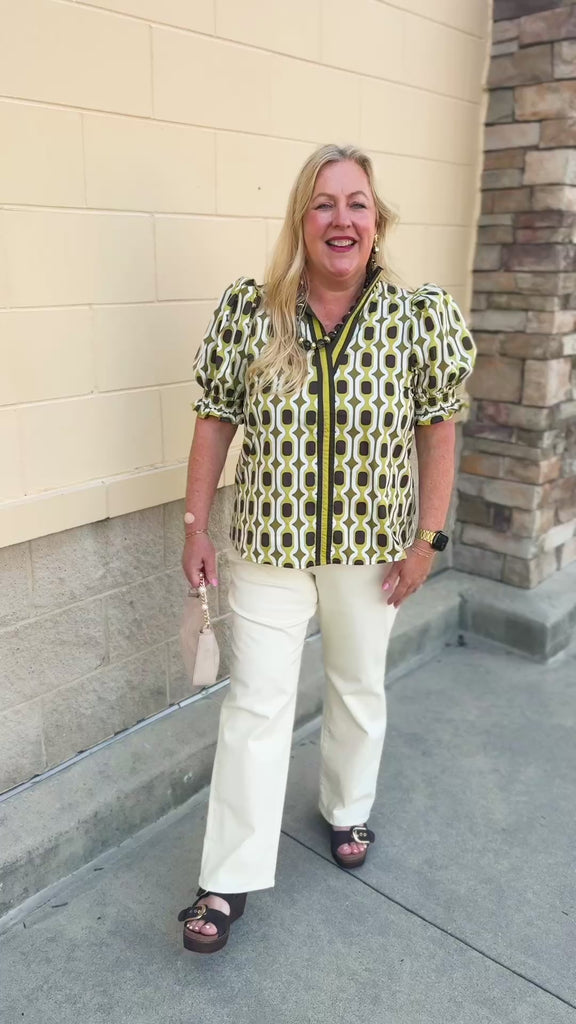 Dark green short sleeve blouse with ruffled sleeves, ruffled collar, V-neckline, chain pattern, and striped front detail