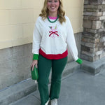 Martini Mistletoe Sweater in cream with a martini glass and red bow, light pink neckline trim, green sleeve trim, and red hem