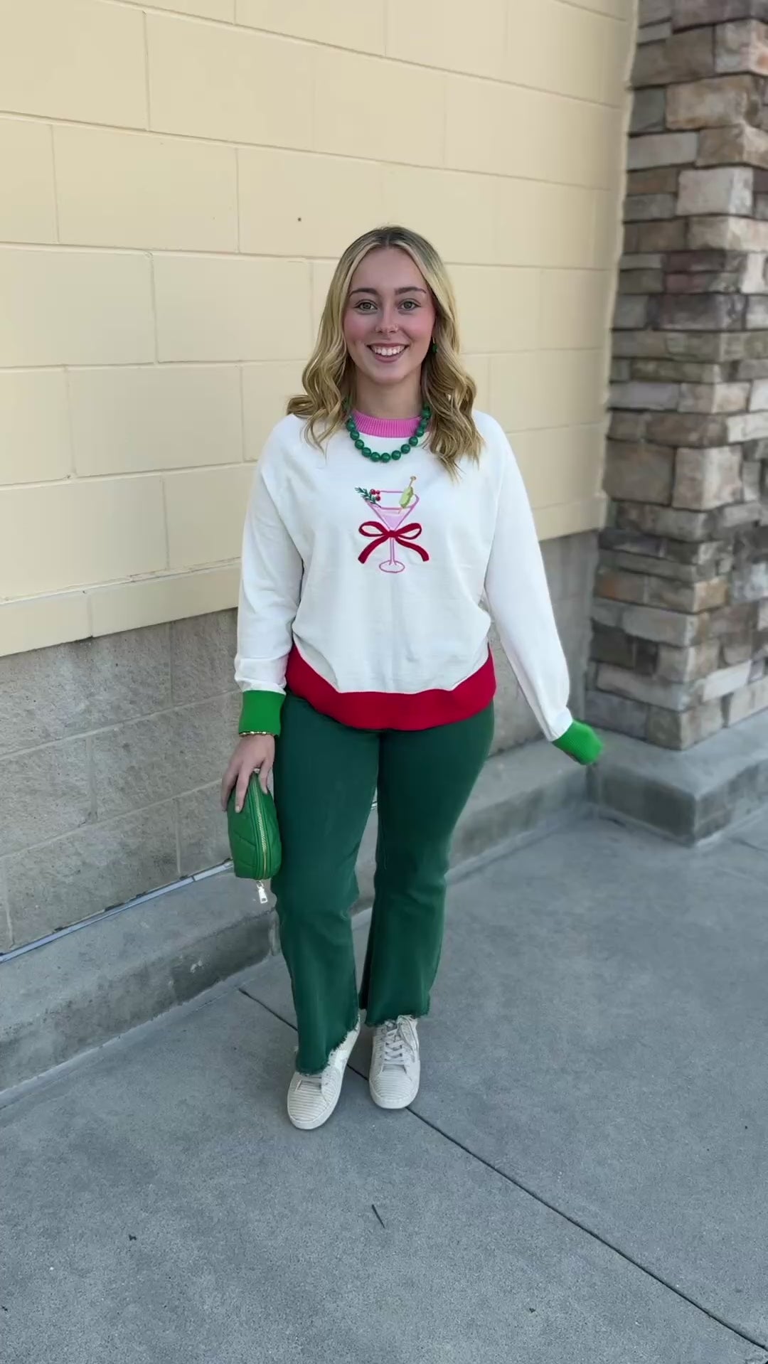 Martini Mistletoe Sweater in cream with a martini glass and red bow, light pink neckline trim, green sleeve trim, and red hem