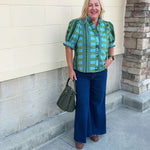[Entro] Willow Embroidered Blouse featuring a green and light blue geometric pattern, V-neckline, puff sleeves, dark green trim, and embroidered details.