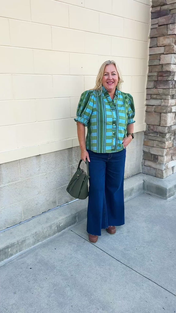 [Entro] Willow Embroidered Blouse featuring a green and light blue geometric pattern, V-neckline, puff sleeves, dark green trim, and embroidered details.