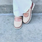 Tan woven Mary Jane flats with buckle straps and lug sole.