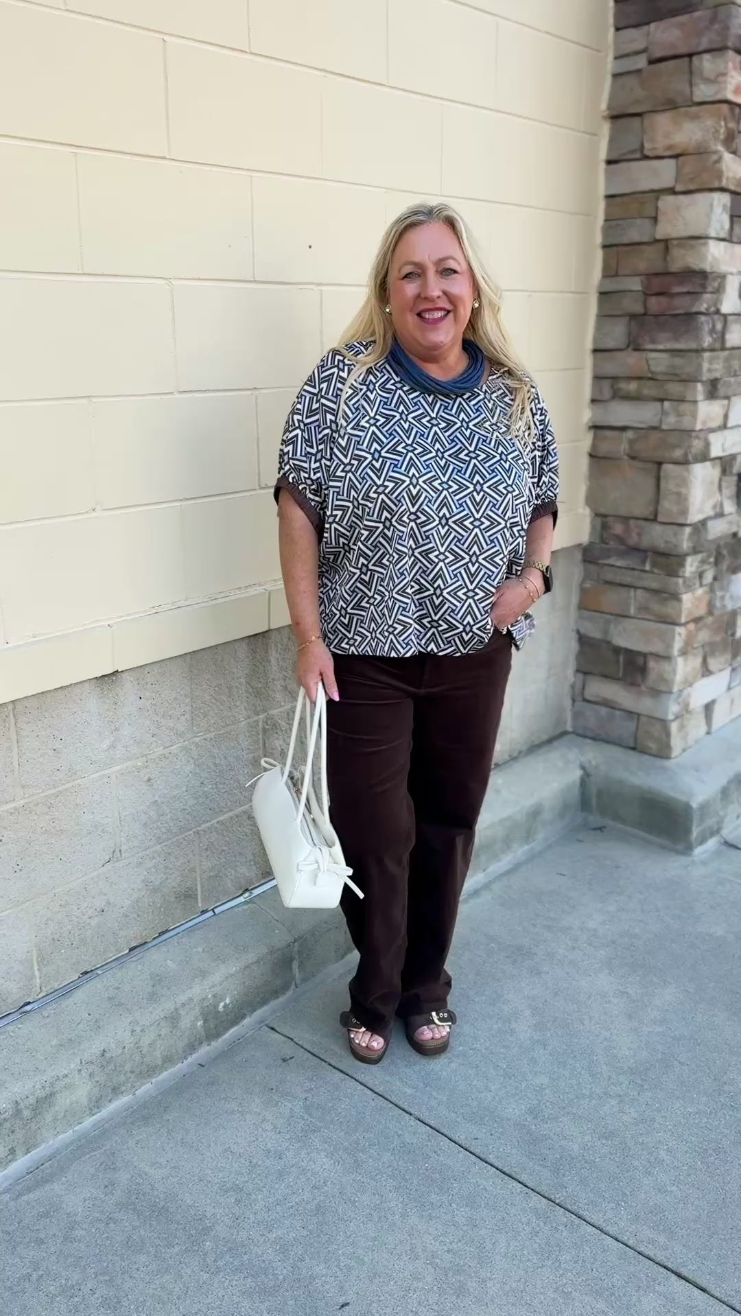 Mosaic Daydream blouse with a blue, brown, and white geometric print