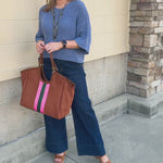 Light blue long-sleeve knit sweater with a button-down front and contrasting brown buttons