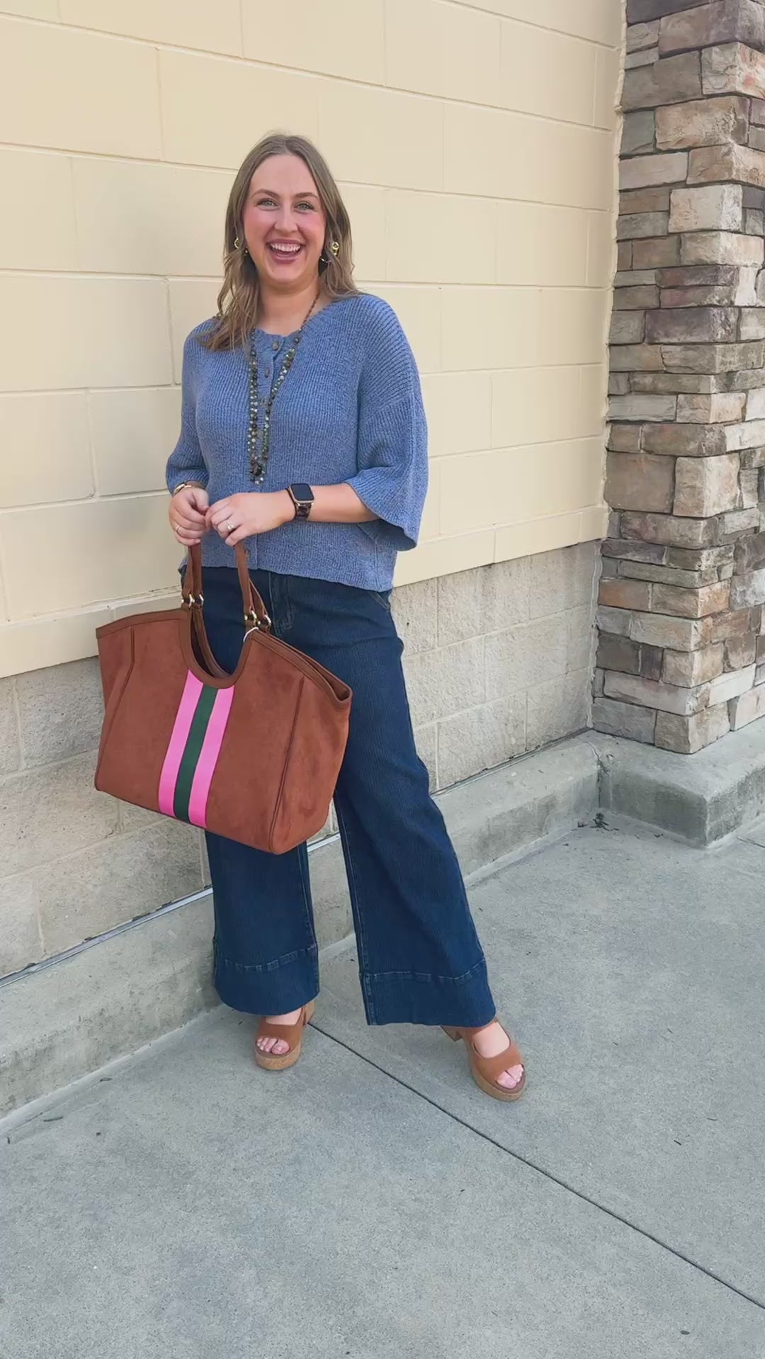 Light blue long-sleeve knit sweater with a button-down front and contrasting brown buttons